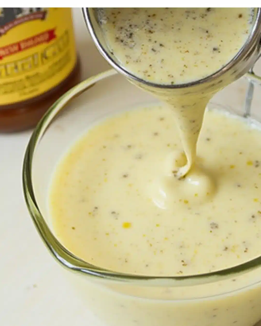 New Orleans soaked salad dressing recipe in a bowl with fresh ingredients