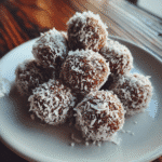 Moose farts recipe dessert bites stacked on a plate with coconut coating